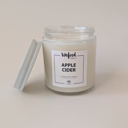 A 4-ounce soy candle in a clear glass jar with a white wax fill and a white label reading 'Waford Candle Co. APPLE CIDER'.