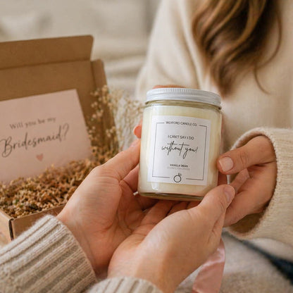 Person handing a personalized bridesmaid proposal candle to a friend