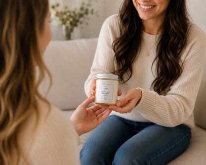 A woman handing her friend a bridesmaid proposal candle gift.
