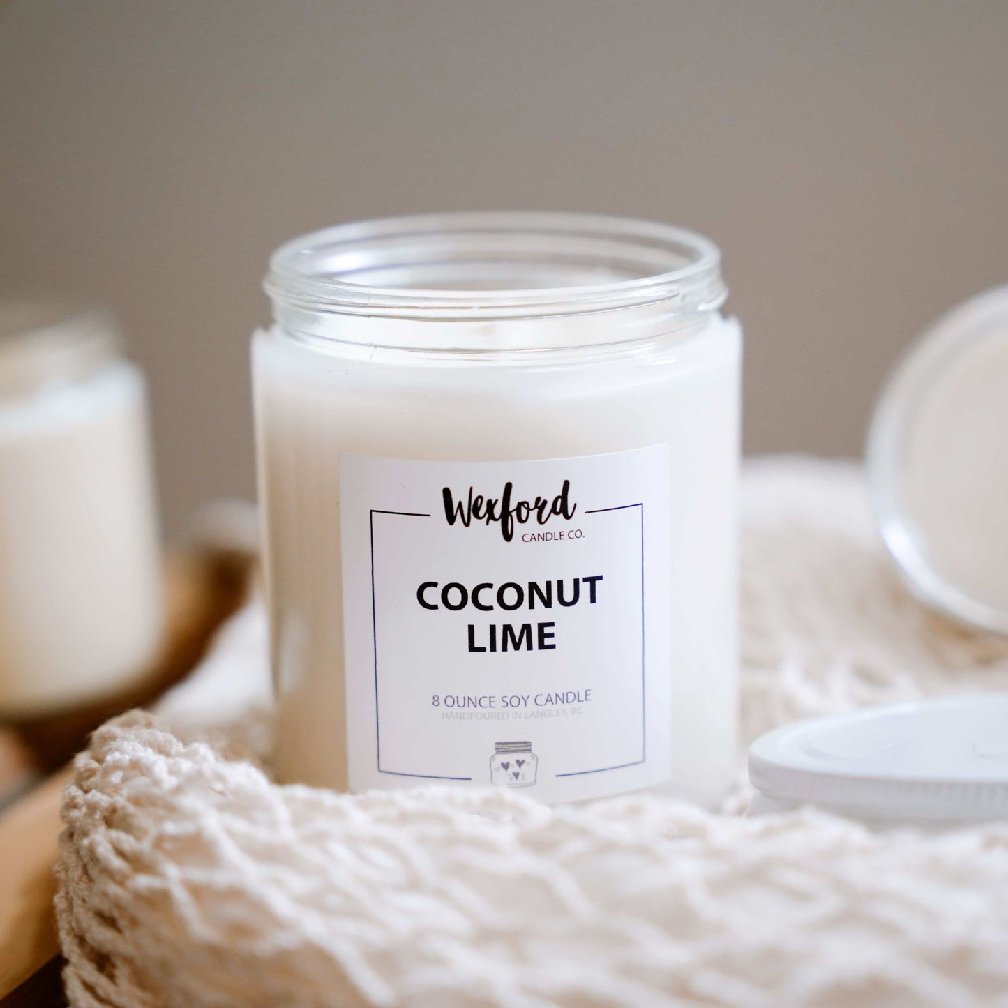 Coconut Lime candle with a label on a textured surface